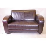 An Art Deco style two seater settee with oxblood leather upholstery