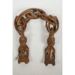 An African carved wood one piece double link chain with figures to the ends, 33" long