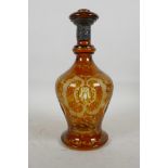 A Bohemian flash cut amber glass decanter, decorated with scrolls, animals and birds, with