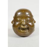 A filled brass four faced Buddha head paperweight, impressed 4 character mark to base, 4½" high