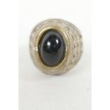 A rare Roman ring with castle set cabochon stone and diamond cut shoulders