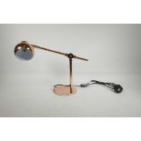 A contemporary rose gold coloured metal Anglepoise style desk lamp, 16½" long