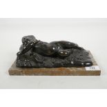 A bronze figure of a sleeping child on a sheepskin rug, mounted on a marble plinth, 10" x 5"