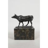 A bronze figure of a bull, mounted on a marble plinth, 6" high