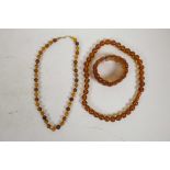 Two amber style bead necklaces, longest 20", together with an amber style panel bracelet