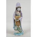 A Chinese porcelain figure of Quan Yin, painted in naturalistic colours, 12½" high