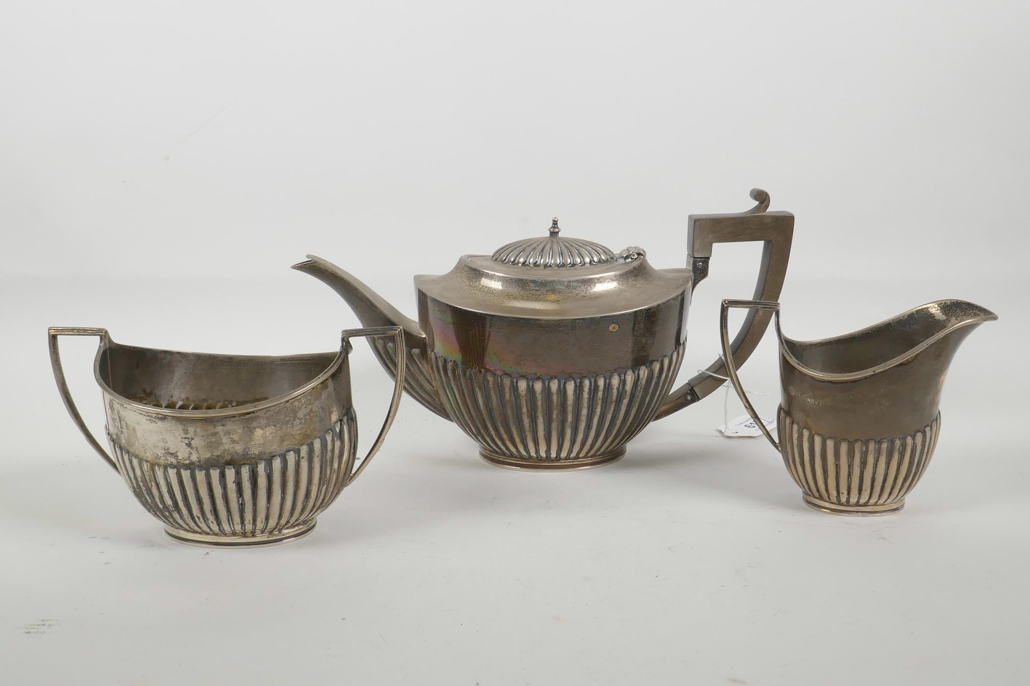 A silver Queen Anne style teapot, jug and sugar bowl by Alexander Clark & Co Ltd of Birmingham,