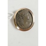 A gold framed stone cameo brooch carved as a classical figure, 1¼" long