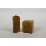 A Chinese amber soapstone seal carved with flowers and calligraphy, 1½" square, together with