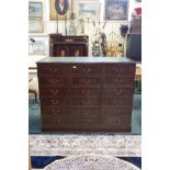 A mahogany veneered three part filing cabinet, comprising nine drawers, and a leather inset top,