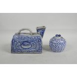 A Chinese blue and white porcelain water jug with square spout and all over stylised decoration,