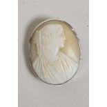 An American silver framed shell cameo brooch, carved as a classical figure, 2" long