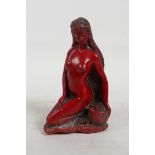 A cinnabar lacquer style composition figure of a female nude, 5½" high