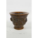 A Chinese faux horn libation cup with carved kylin decoration, impressed seal mark to base, 3"