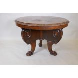 A C19th French walnut veneered centre table, with carved edge top, raised on three shaped supports