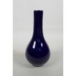 A Chinese dark blue glazed bottle vase, the base marked with two concentric rings and six