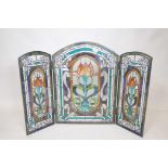 A stained glass triptych fire screen with Art Nouveau style decoration, centre panel 20" x 28", side