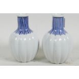 A small pair of Japanese blue and white porcelain vases of ribbed gourd form, 4 character mark to