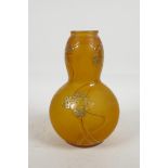 An amber coloured double gourd shaped glass vase with applied enamelled and gilt decoration of