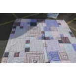 A good quality king size bedspread with blue and pink geometric design