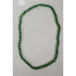 A string of green jade beads, 32" long