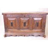An C18th/C19th French oak triple panel coffer with moulded an carved decoration, raised on sleigh