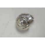 An unmarked silver vesta case in the form of a shell, 2" x 1½"