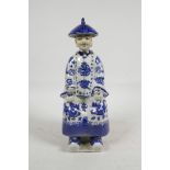 A Japanese blue and white porcelain seated figure holding two cups, character inscription verso