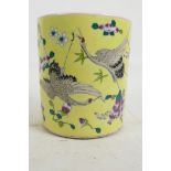 A Chinese yellow ground porcelain brush pot decorated with cranes flying amongst flowers, 6" high,