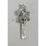 A sterling silver topped baby's rattle in the form of a puppy, 3" long