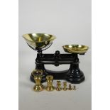 A set of cast iron and brass kitchen scales with brass bell weights, 13" wide