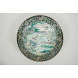 A Chinese famille verte porcelain dish with storks by a river, six character mark to base, 8"