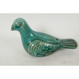 A Persian green glazed porcelain figure of a pigeon, 5" long