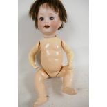 A Heubach 300-4 baby doll with bisque head having closing eyes and open mouth with two teeth,