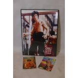 A framed poster of Bruce Lee from Enter the Dragon and two kung-fu magazines featuring Bruce Lee,
