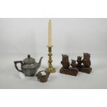 An eclectic lot containing C19th brass weights, a brass candlestick, a C19th silver plated teapot