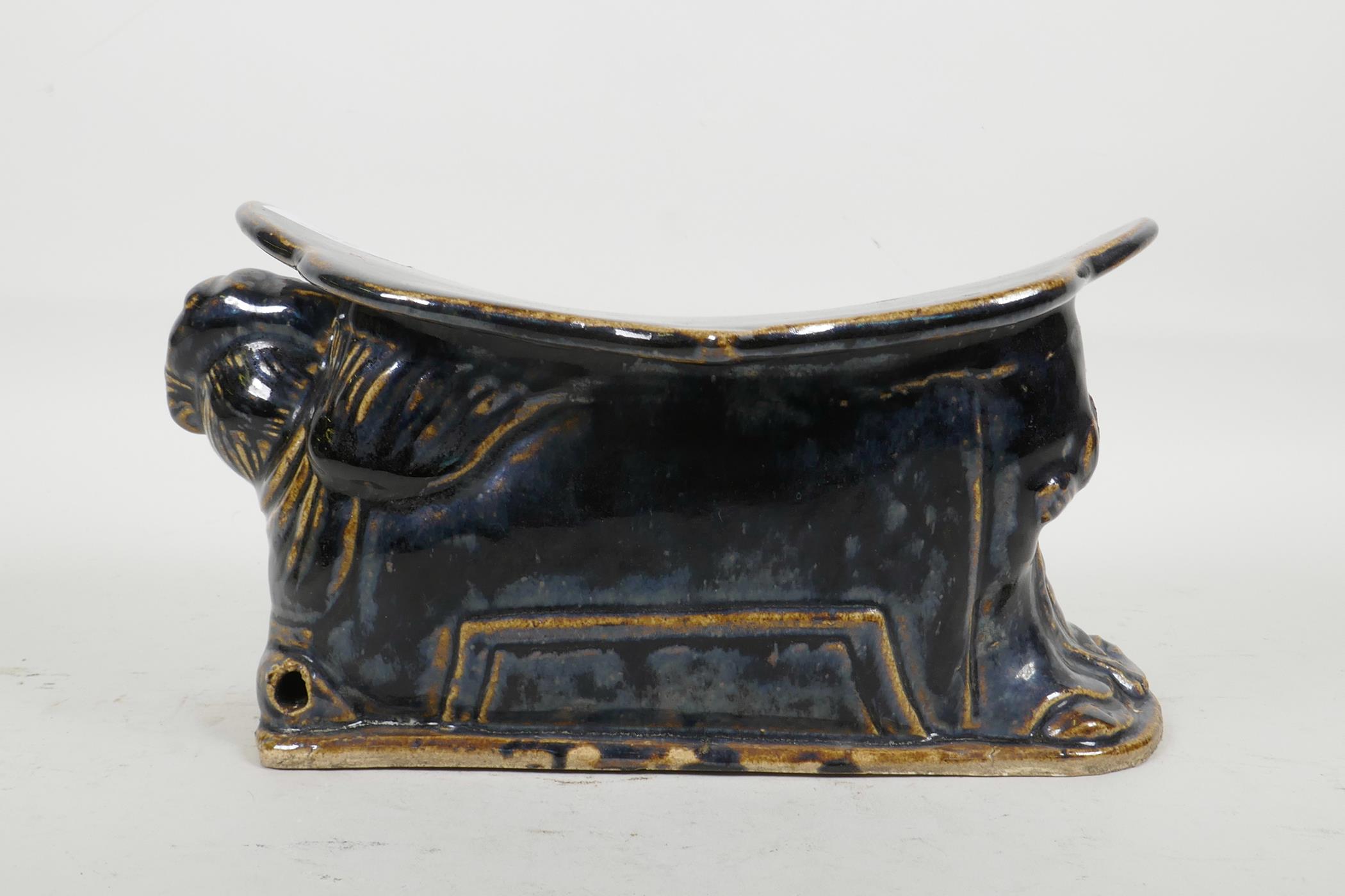 A Chinese Cizhou kiln pottery head rest moulded in the form of a reclining figure, with blue black - Image 3 of 4