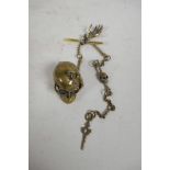 An unusual brass Albert style chain with skull and skeletal hand decoration, 12" long