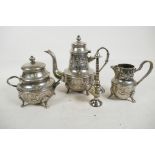 An Islamic silver plated three piece tea set with ornate chased and engraved decoration, teapot 8"