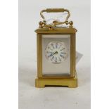 A miniature brass cased carriage clock with enamelled dial and Roman numerals, with key, A/F, 2¼"