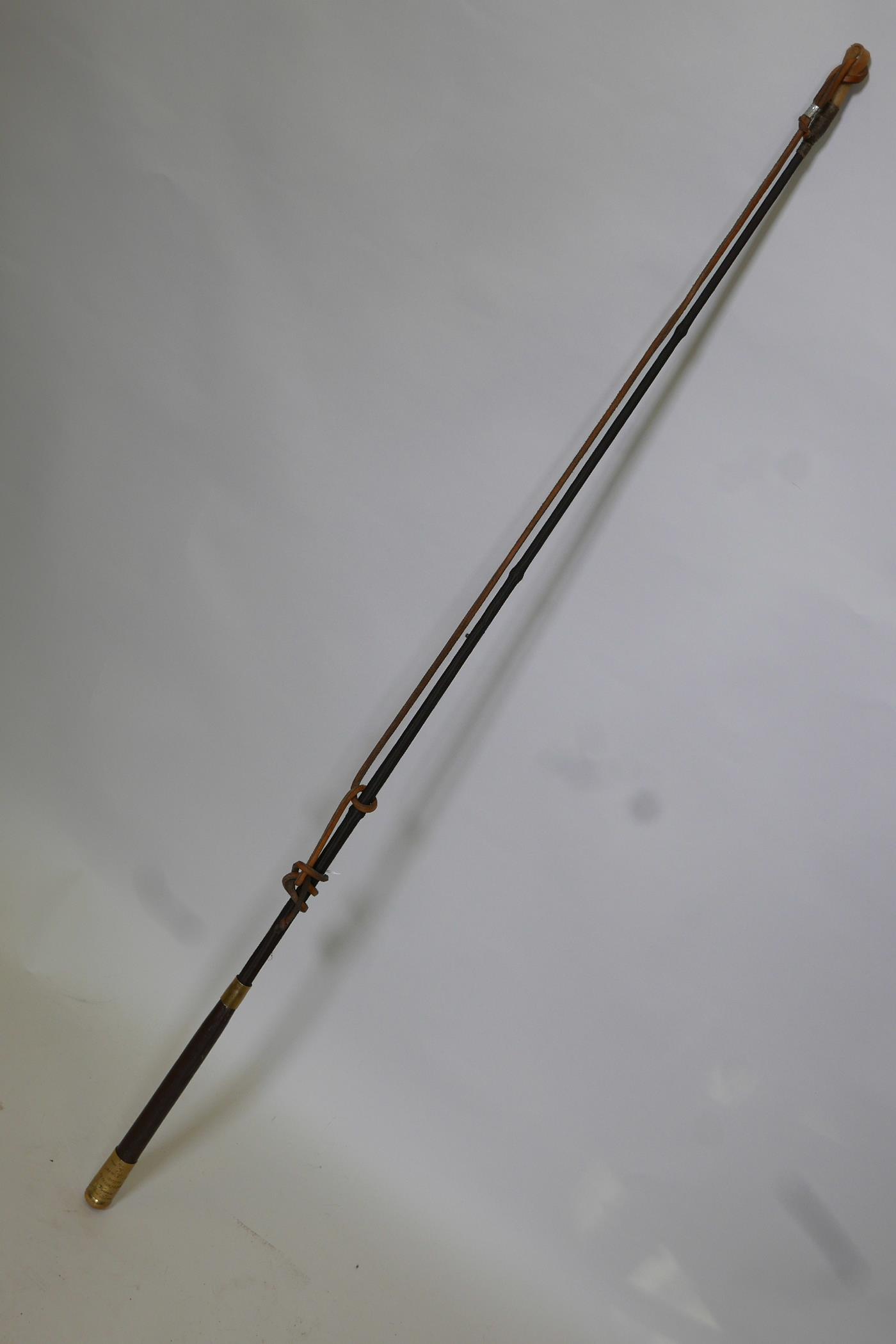 A carriage whip by Crawley & Sons of Peterborough, with steel core whip shaft, leather handle and