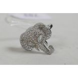 A 925 silver and cubic zirconium encrusted ring in the form of an elephant head, with opalite set