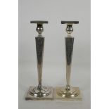 A pair of American sterling silver candlesticks of inverted square tapered form on square bases,