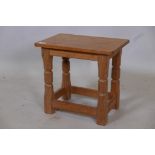 Foxman, Malcolm Pipes, an oak stool, the legs with carved fox mask signature, 16" x 11" x 15"
