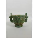 A Chinese green glass two handled censer with archaic style decoration, 4" high x 4½"
