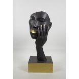 A contemporary brass sculpture of a face, 16" high