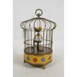 A Chinese brass birdcage automaton clock with cloisonné banded decoration, 8½" high x 5½" diameter
