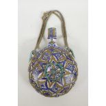 A North African pottery flask painted with geometric patterns in blue, green and brown enamels,