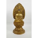 A Chinese gilt metal Buddha seated on a lotus throne, 4 character mark to base, 15" high