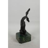 A stylised bronze figure of a kangaroo, mounted on a marbled plinth, 8½" high